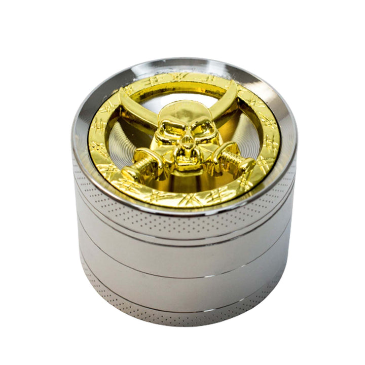 Close-up of decorative skull and swords lid on 2.15 inch steel herb grinder