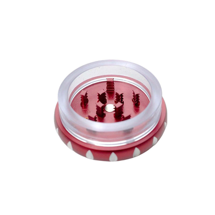 Open view of Genie Aluminum Weed Grinder in red showing sharp teeth