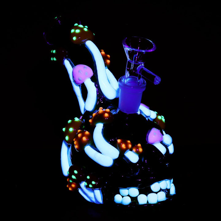 Nighttime view of Glow in the Dark Skull Mushroom Bong with colorful 3D mushrooms