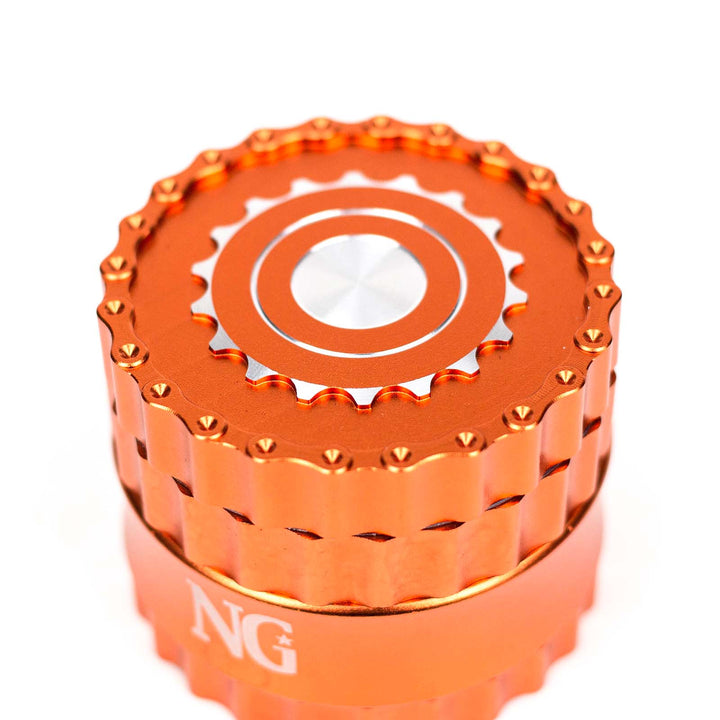 Top lid of NG 4-Piece Aluminum Gear Grinder showing gear-shaped design