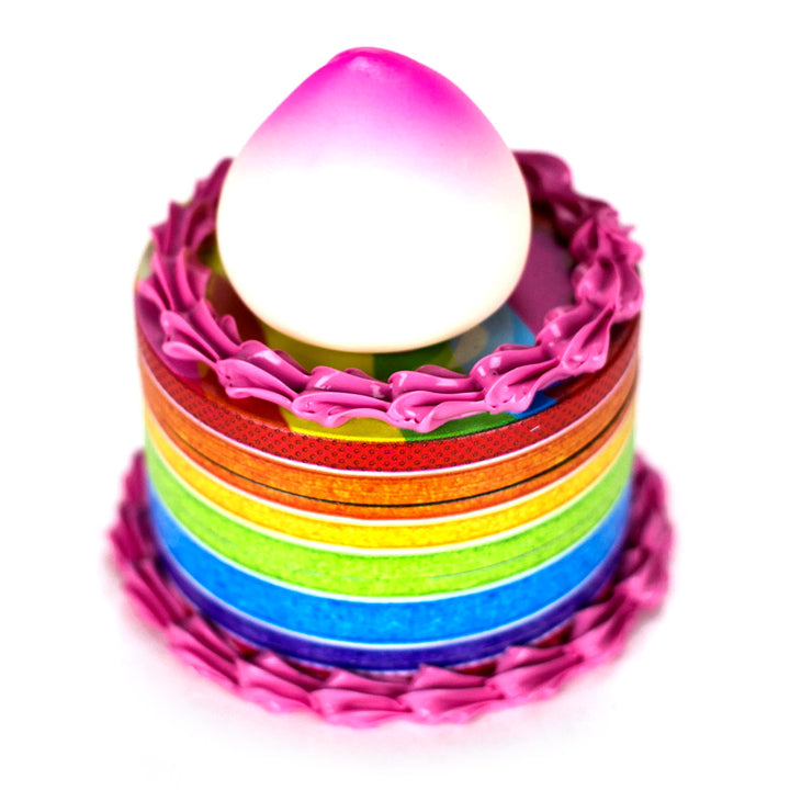 Close-up of cute peach topper on the Rainbow Cake Herb Grinder lid