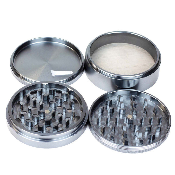 Flat lay display of all four parts of the Pitara Aluminum 100mm Extra Large Herb Grinder