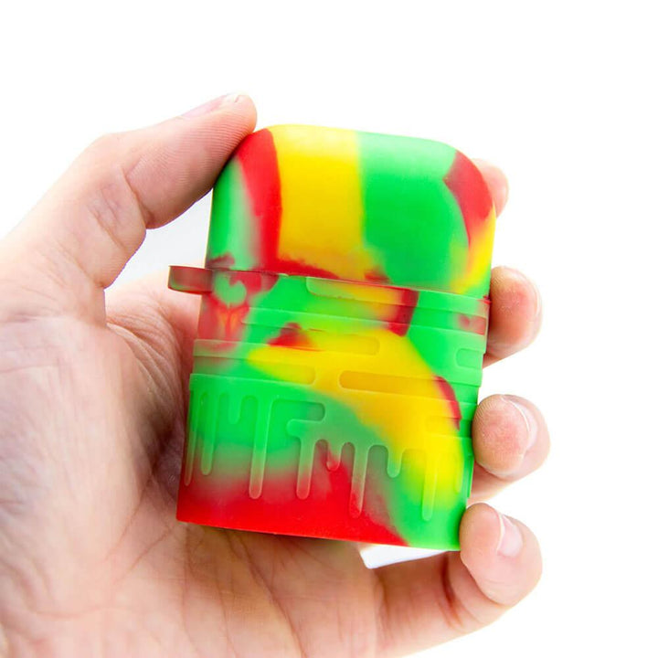 Colorful Rasta Silicone One Hitter Shown in Hand – Pocket-Sized